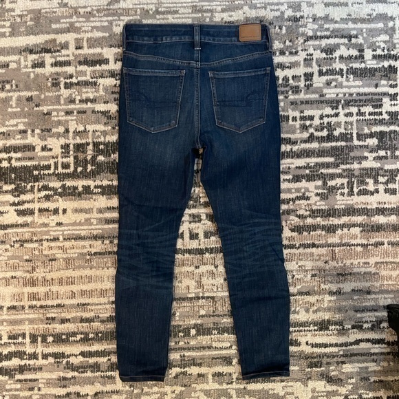 American Eagle | Highrise Next Level Stretch Destressed Dark Blue Jean - Picture 10 of 11